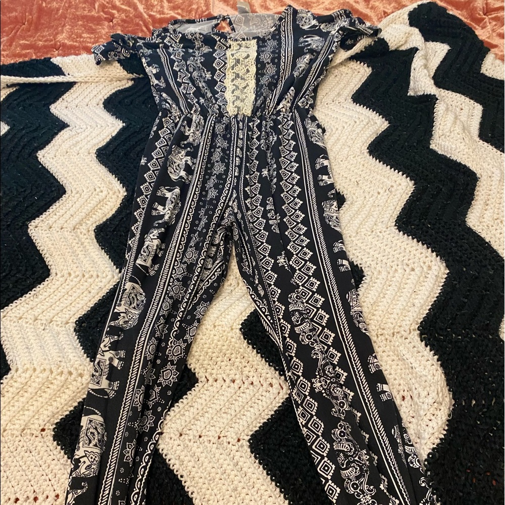 Black off the shoulder patterned romper.